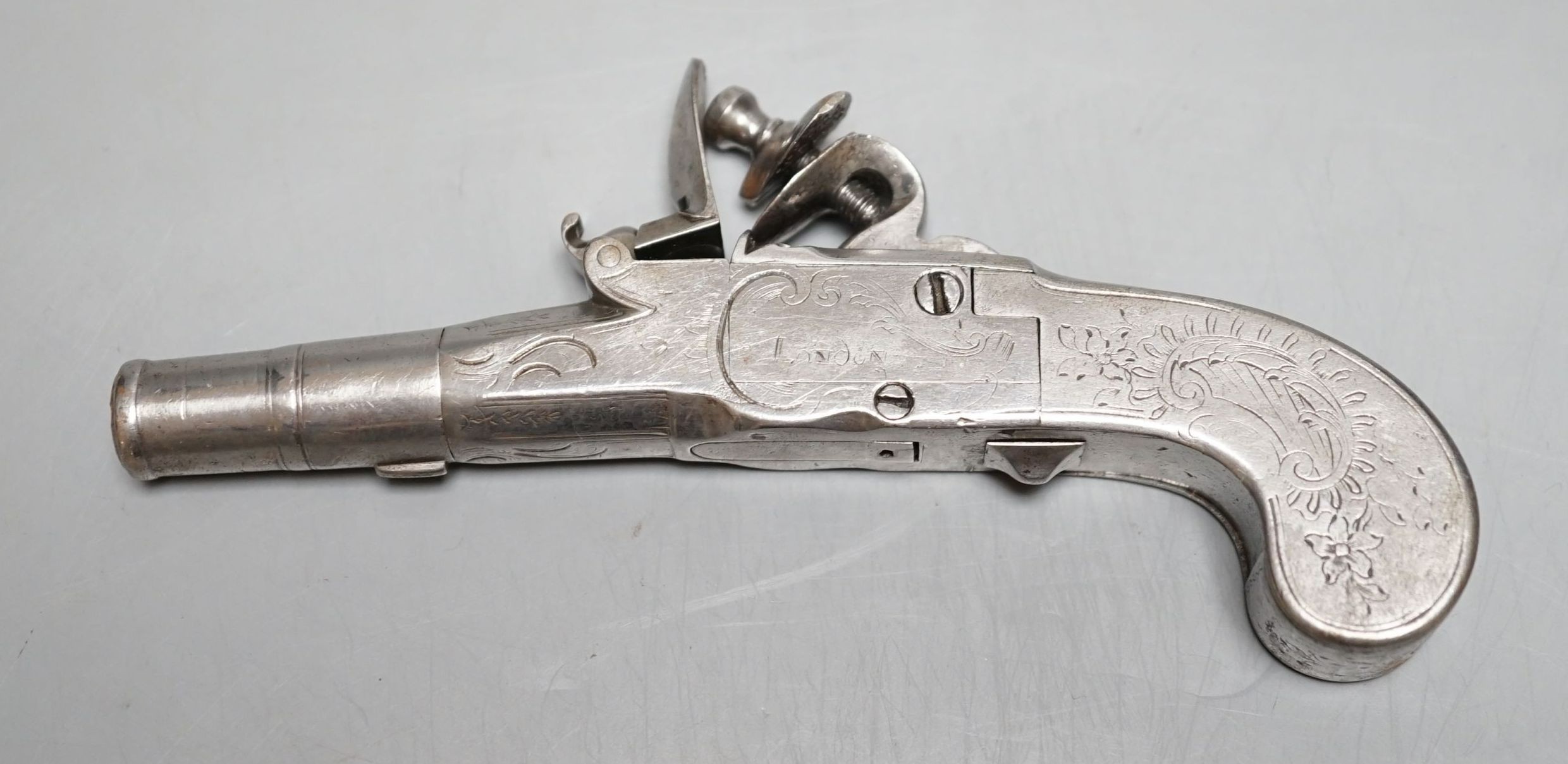 An 18th century steel flintlock pistol, maker London Segalas, 15 cms long.